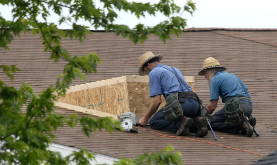 Amish working on roof Amish working on roof